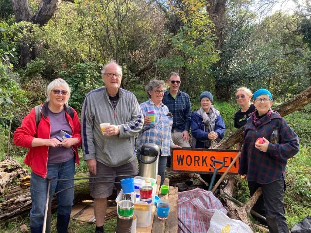 Group photo of people in garden looking at the camera