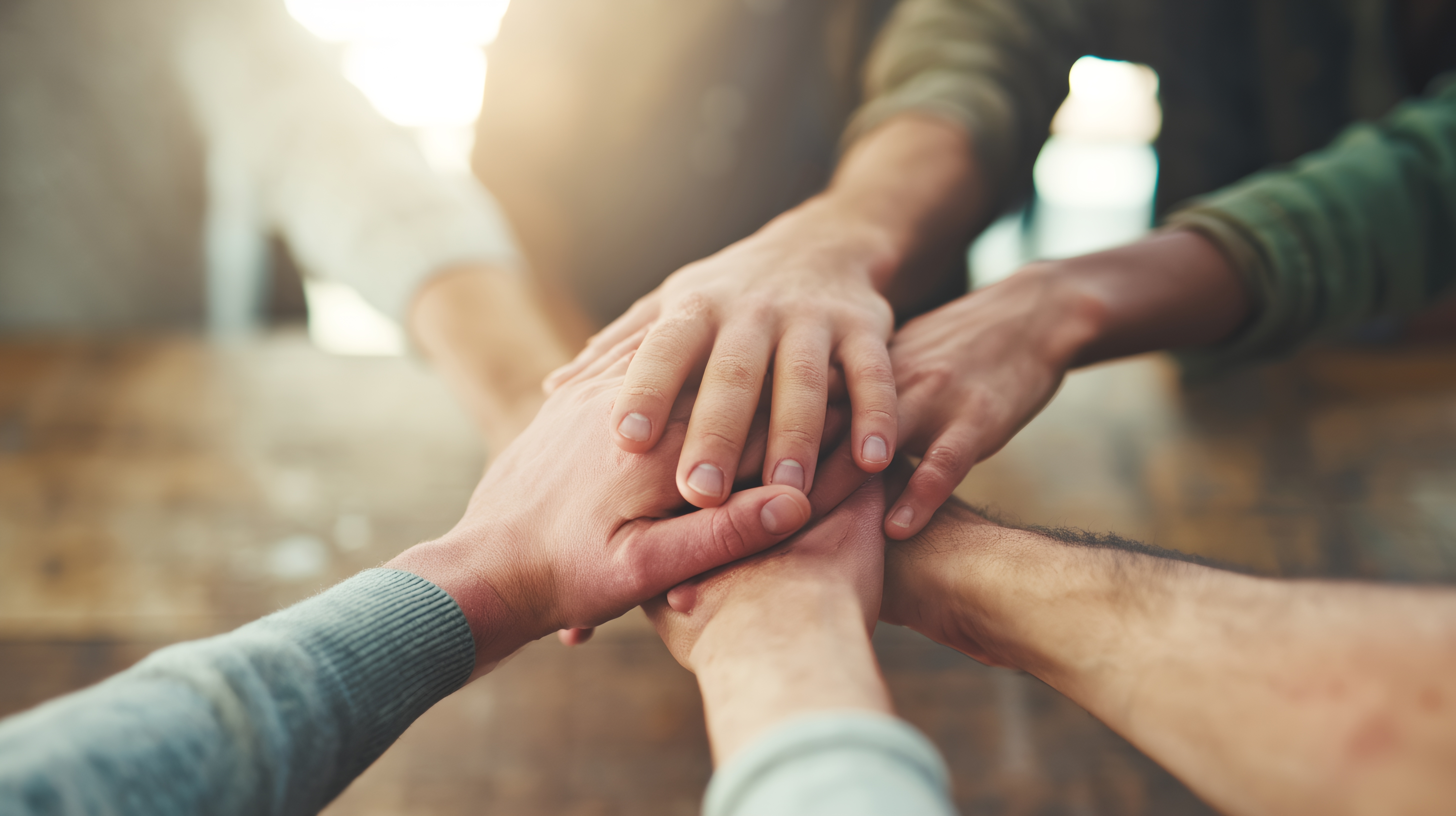 Hands of several people stacked together