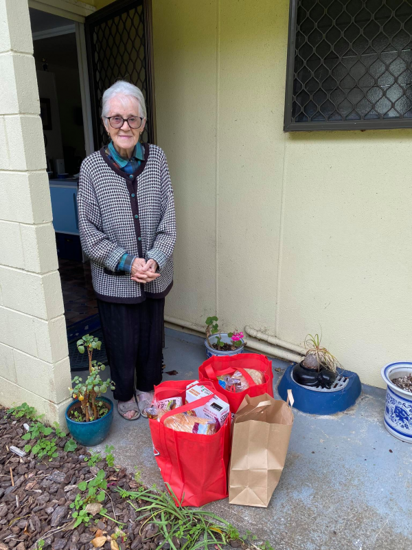 Picture of a woman collecting a food delivery from Age Concern Auckland