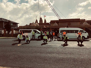 Picture of volunteers outside the International Swaminarayan Satsang Temple